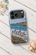 Hilton Head Dolphin Strand Feeding tough phone case on a white wooden table